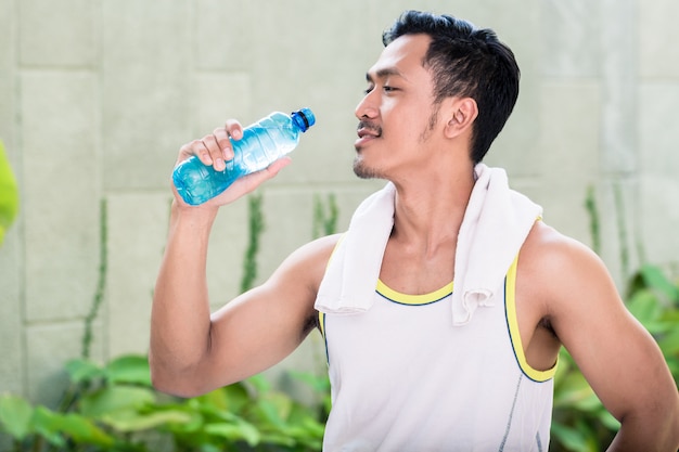 Asian man working out in his garden