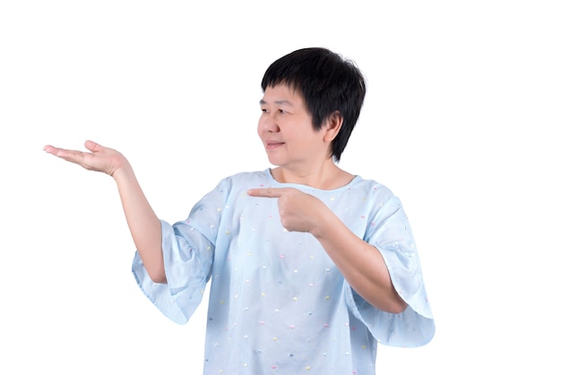 Asian Middle-aged woman opening her hand and pointing finger for concept placing a sign or object , isolated on white background