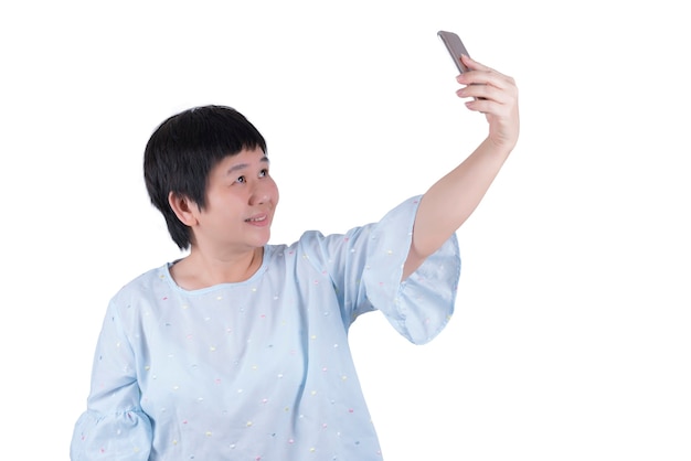 Asian Middle-aged woman taking selfies isolated on white background