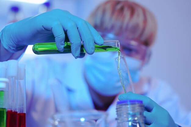 Photo asian middleaged male scientist conducts research in a laboratory