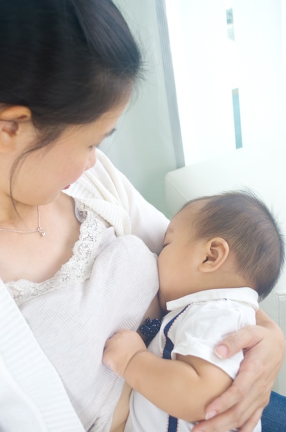 Asian mother breastfeeding her baby boy