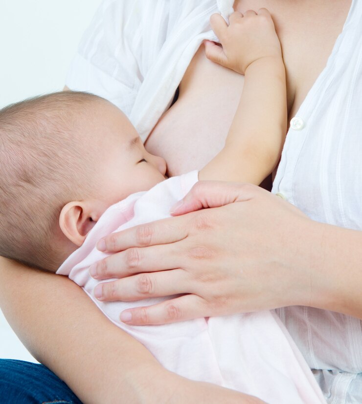 Asian mother breastfeeding her baby girl