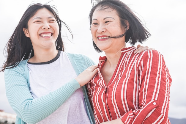 Asian mother and daughter having fun outdoor