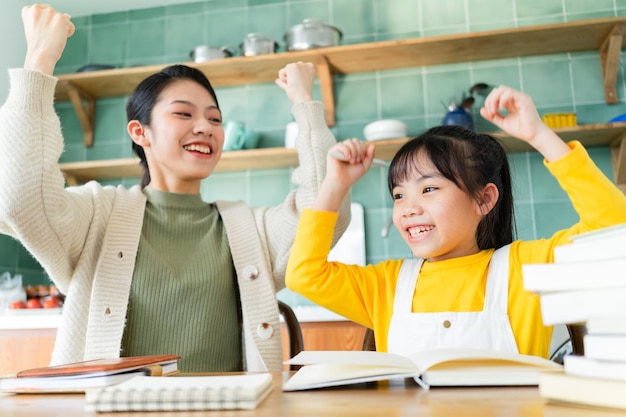 Asian Mother and daughter studying together at home