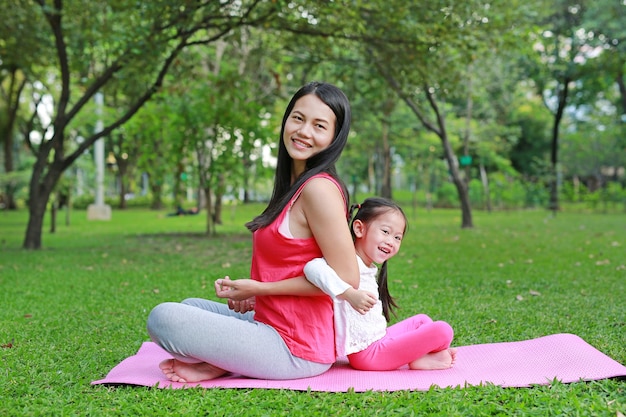 Asian mother and her daughter doing exercise 