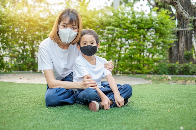 Asian mother and her son wearing protective masks