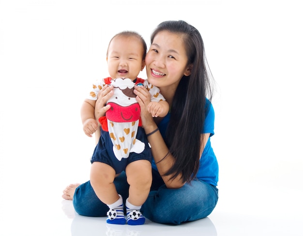 Asian mother playing with baby boy