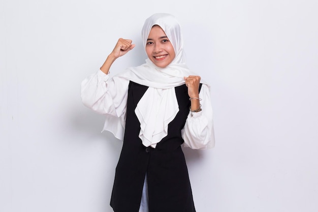 Asian muslim business woman happy and excited celebrating victory expressing big success on white