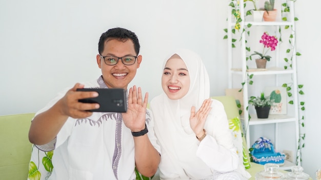 Asian Muslim families celebrate Eid together while on video calls