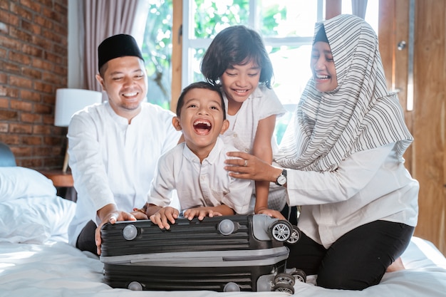 Asian muslim family prepare suitcase for carried when mudik