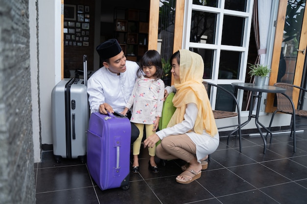 Asian muslim family with suitcase