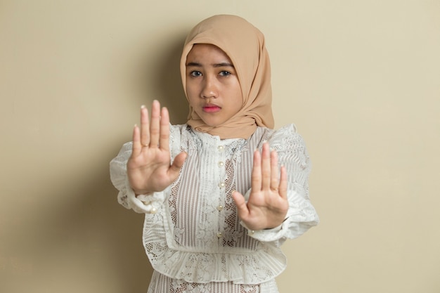 Asian muslim hijab woman show stop hands gesture