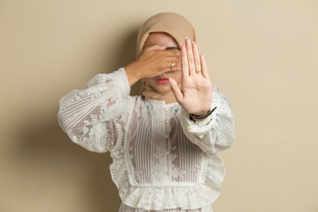 Asian muslim hijab woman show stop hands gesture