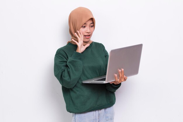 asian muslim hijab woman using her laptop computer isolated on white background