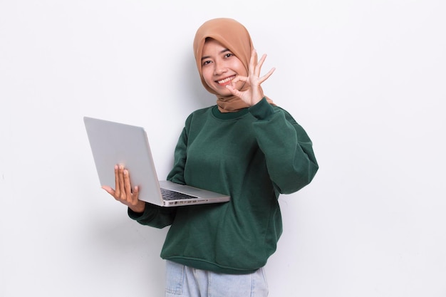 asian muslim hijab woman using her laptop computer isolated on white background