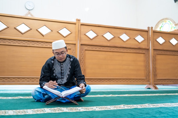 Asian muslim male reading Quran