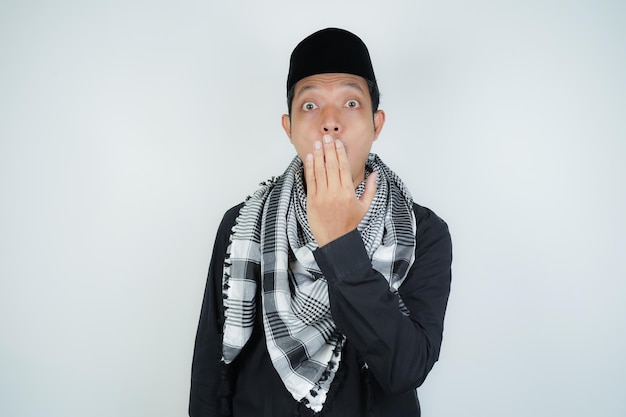 asian muslim man covering his mouth with hand or bad breath wearing Arab turban sorban on