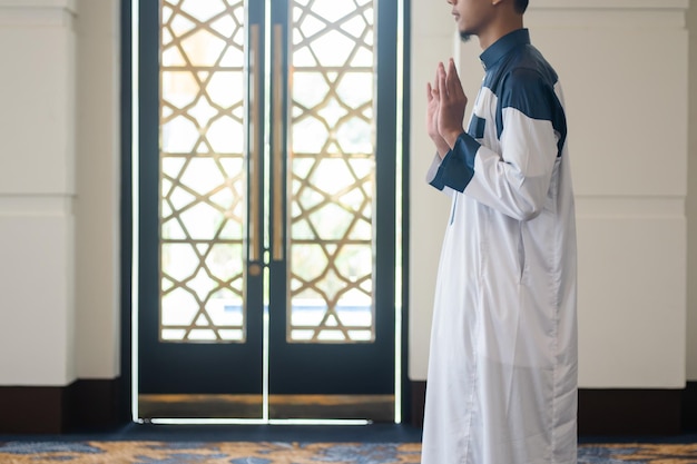 Asian muslim man solat and takbir take his hands up Islam praying Islamic concept