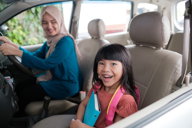 Asian muslim mother taking her daughter to school in the morning