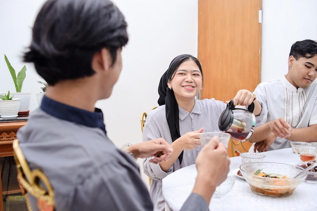 Asian muslim people having dinner break fasting together at home during ramadan