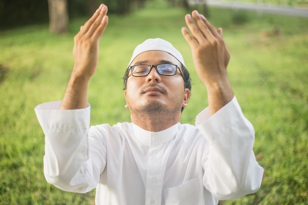 Asian muslim praying To Allah God Of Islam.