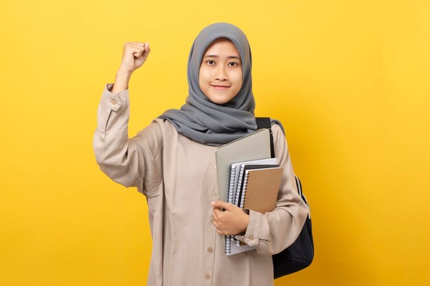 Asian muslim student girl happy raised hand celebrating success