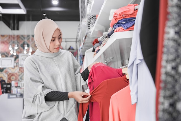 Asian muslim woman buy clothes at fashion boutique