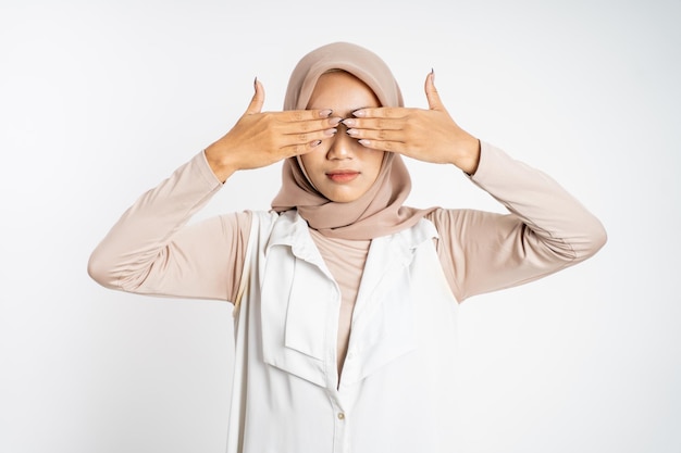 Asian muslim woman closing eyes with both palms concept