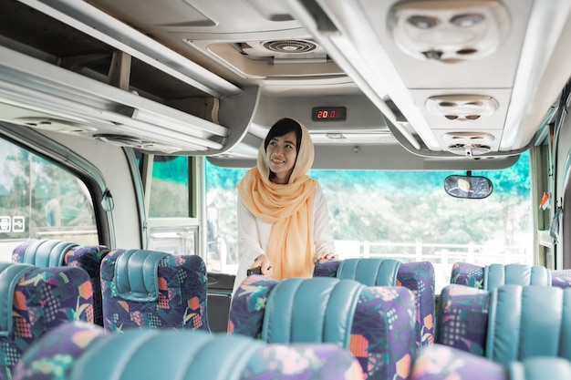 Asian muslim woman doing eid mubarak traveling back to her hometown by riding a bus