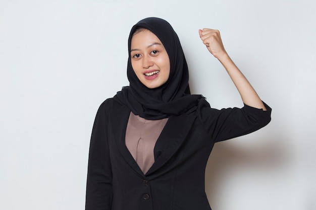 Asian muslim woman happy and excited celebrating victory expressing big success