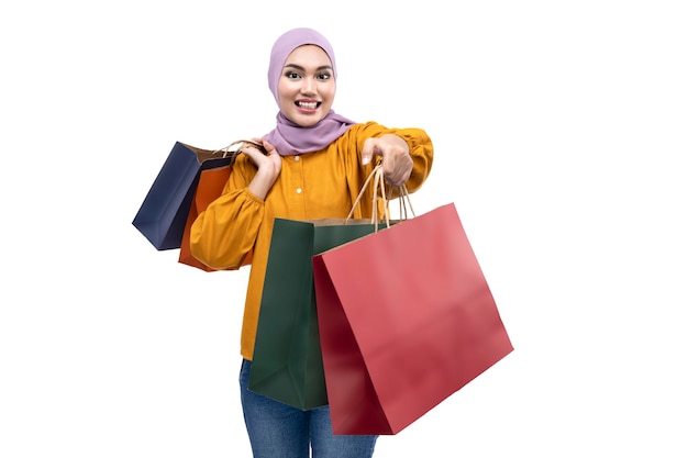 Asian Muslim woman in a headscarf holding shopping bags