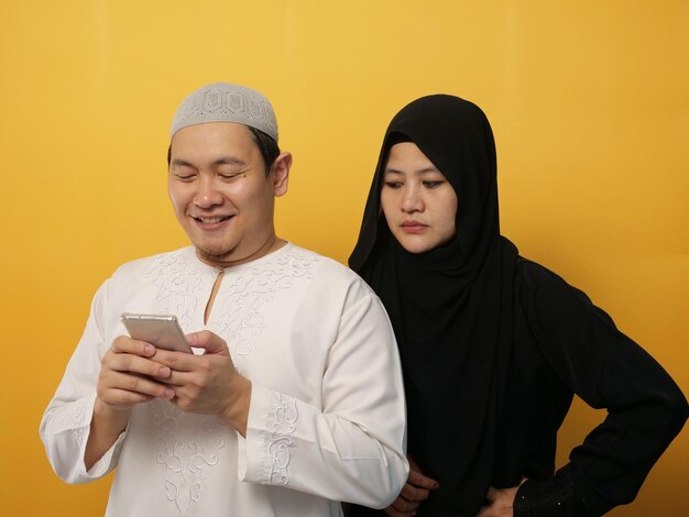 Photo asian muslim woman looked jealous her husband man chat on phone bad couple relationship trouble