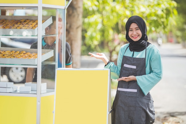 Asian muslim woman small business owner and her food stall