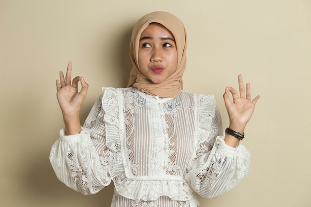 Asian muslim woman wearing hijab with ok sign gesture