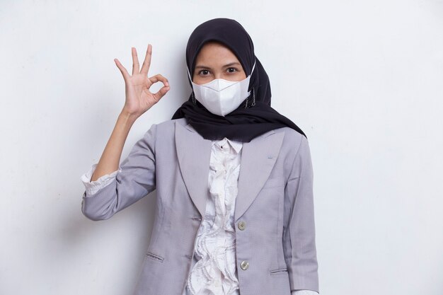 Asian muslim woman wearing medical face mask to protection corona virus covid19 posing on white