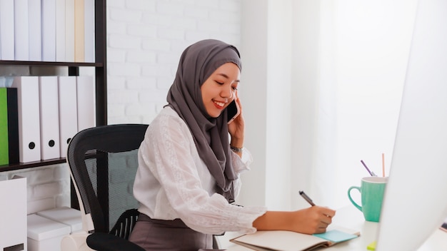 Asian muslim woman working from home