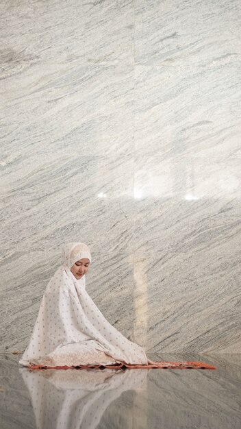 Asian Muslim women praying at the mosque