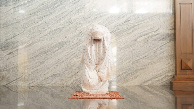 Asian Muslim women praying at the mosque