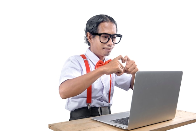 Asian nerd with an ugly face using laptop isolated over white background