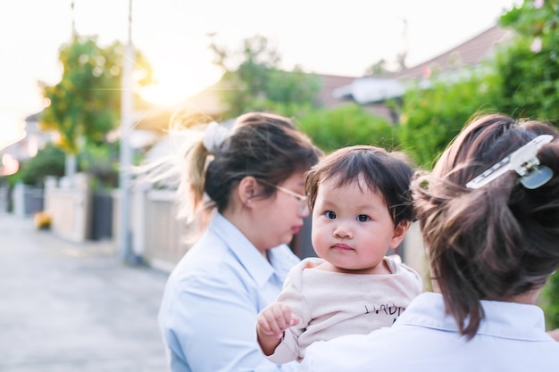 Asian newborn baby kid eye contact with mom cuteness of children with happy family on soft mattress