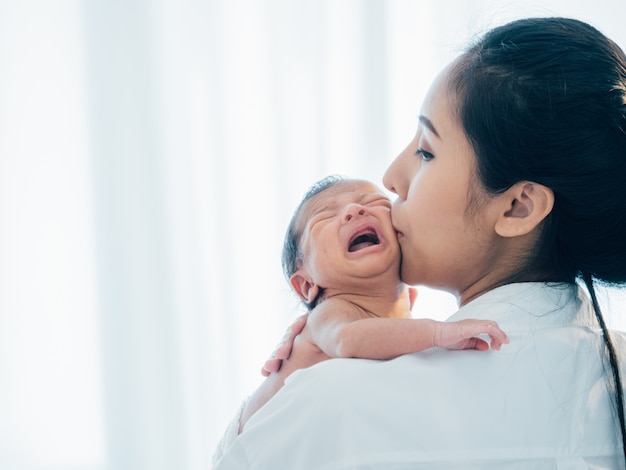 Asian newborn baby with mother