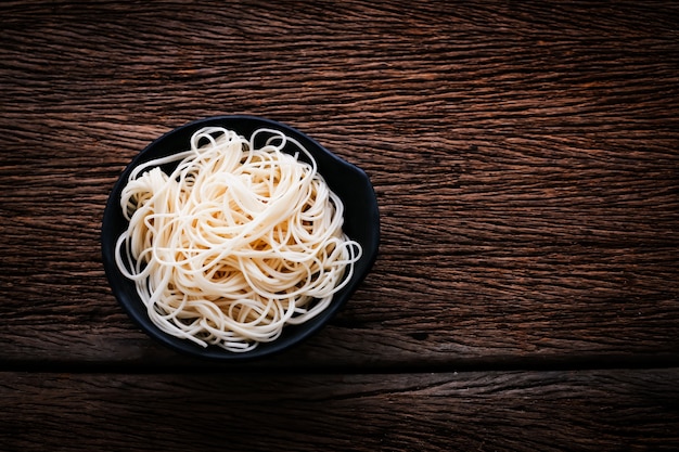 asian noodled in black bowl