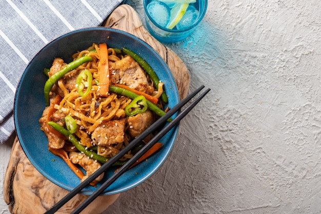 녹색 콩, 당근, 표고 버섯과 함께 데리야끼 소스에 돼지 고기를 넣은 아시아 국수.