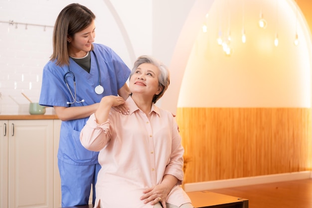 Asian nurse taking care of senior woman in nursing home Healthcare and medical service