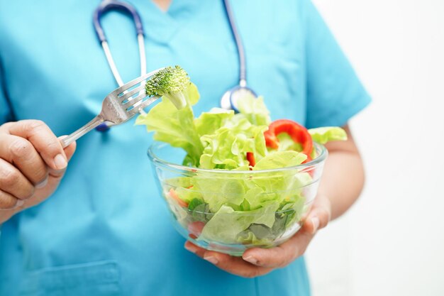 Asian Nutritionist holding healthy food for patient in hospital nutrition and vitamin