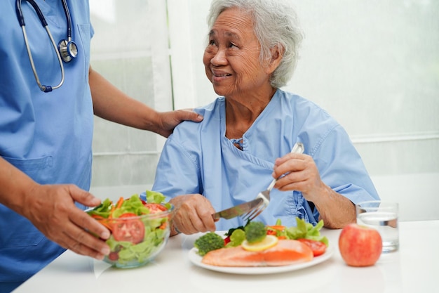 Asian Nutritionist holding healthy food for patient in hospital nutrition and vitamin