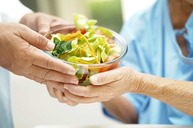 Asian Nutritionist holding healthy food for patient in hospital nutrition and vitamin