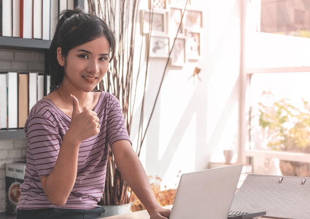 Asian office worker is showing thumb up