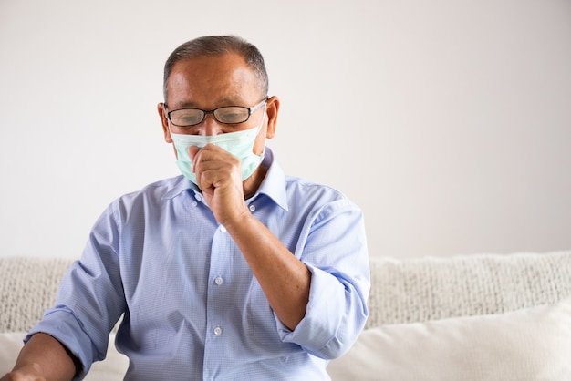 Asian old man wearing Protective face mask and cough. Senior healthcare concept.