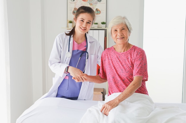 Asian Old Patient woman  Talking with Medical Doctor women in clinic office hospital